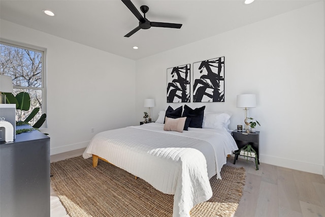 bedroom with ceiling fan and light wood-type flooring