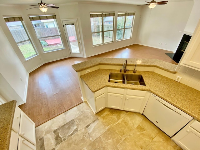 kitchen with ceiling fan, dishwasher, white cabinets, and sink