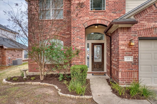 doorway to property featuring a garage and central AC