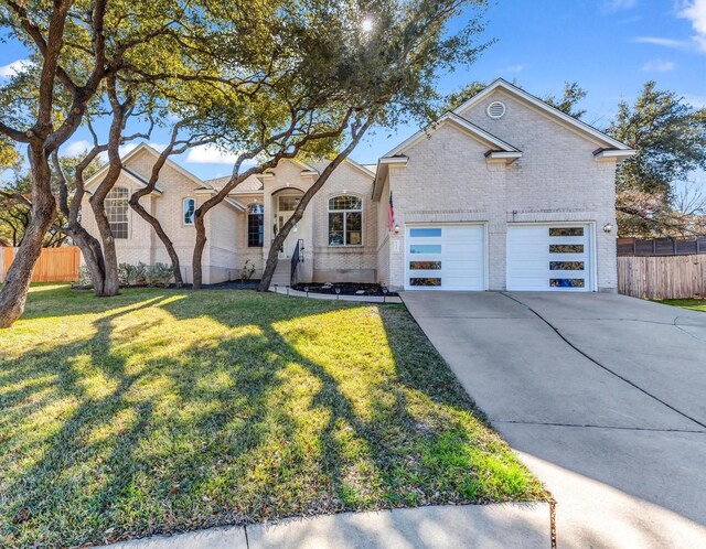 view of front of home with a garage and a front lawn