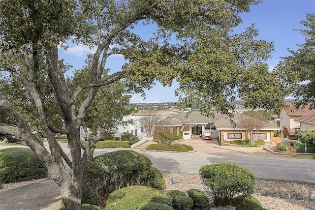 106 Firebird Cv, Lakeway, TX 78734 - obstructed view of property with curved driveway