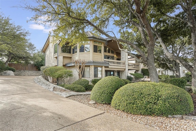106 Firebird Cv, Lakeway, TX 78734 - view of front of home with a balcony and stone siding