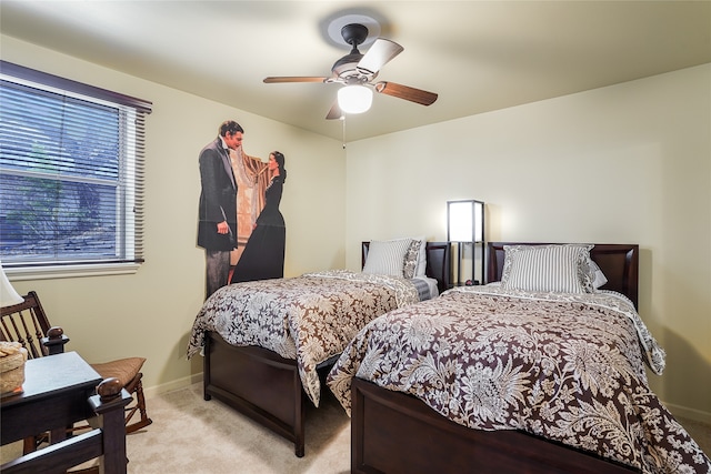 bedroom featuring light carpet and ceiling fan