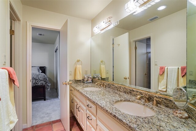 106 Firebird Cv, Lakeway, TX 78734 - full bath with double vanity, tile patterned floors, and connected bathroom