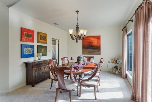 106 Firebird Cv, Lakeway, TX 78734 - dining area featuring light carpet and a chandelier