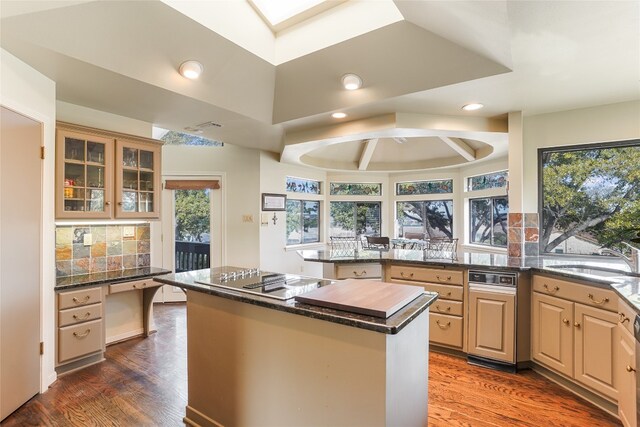106 Firebird Cv, Lakeway, TX 78734 - kitchen featuring a peninsula, stovetop with downdraft, tasteful backsplash, healthy amount of natural light, and recessed lighting