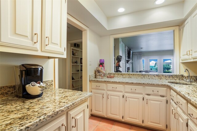 106 Firebird Cv, Lakeway, TX 78734 - kitchen with light stone counters and light tile patterned floors