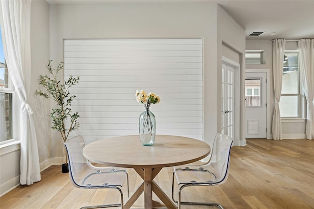 dining room featuring light hardwood / wood-style flooring and french doors