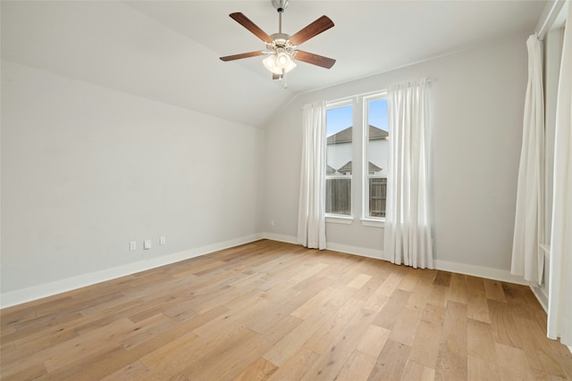 empty room featuring ceiling fan, lofted ceiling, and light hardwood / wood-style floors