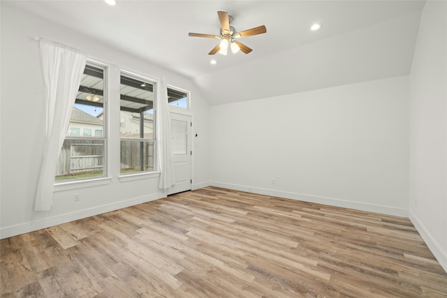 bonus room with vaulted ceiling, ceiling fan, a wealth of natural light, and light hardwood / wood-style floors