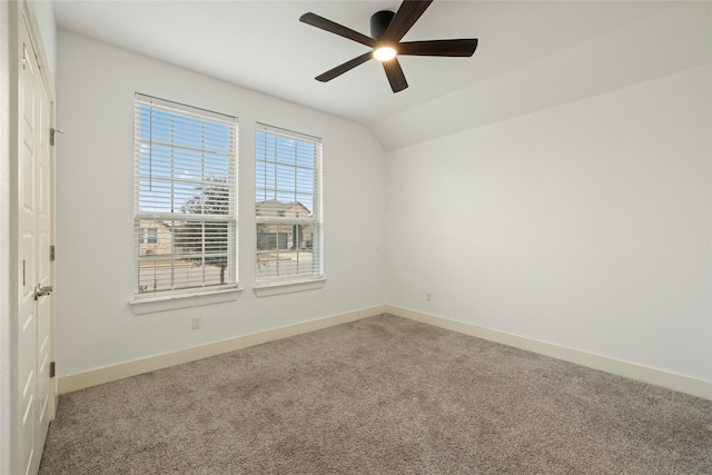 unfurnished room with ceiling fan, carpet flooring, and vaulted ceiling