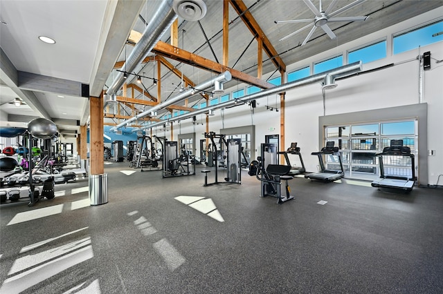 workout area featuring high vaulted ceiling and ceiling fan