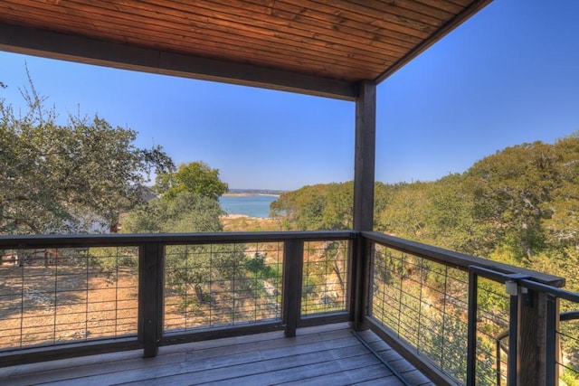 wooden terrace featuring a water view