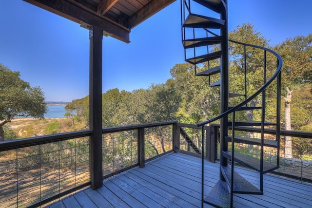 wooden deck featuring a water view