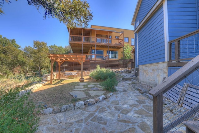 exterior space with a balcony, a pergola, and a patio