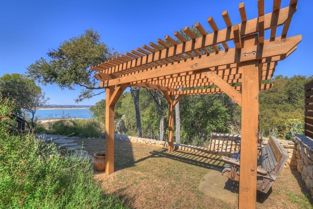 view of yard featuring a pergola and a water view