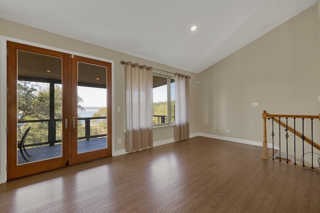 interior space featuring lofted ceiling, hardwood / wood-style flooring, and french doors