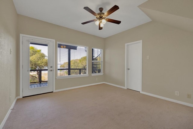 carpeted empty room with lofted ceiling and ceiling fan