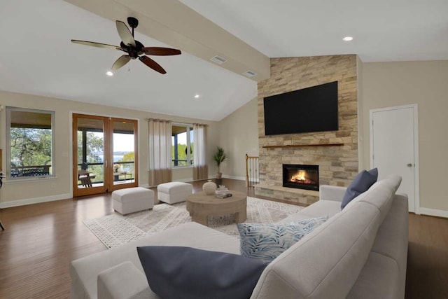 living room featuring french doors, a stone fireplace, high vaulted ceiling, ceiling fan, and hardwood / wood-style floors