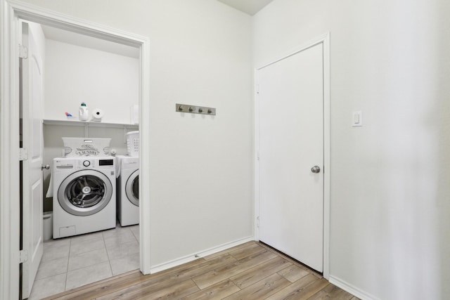 washroom featuring washer and dryer and light hardwood / wood-style flooring