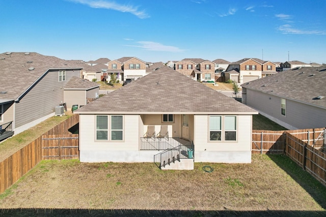 rear view of property with a lawn