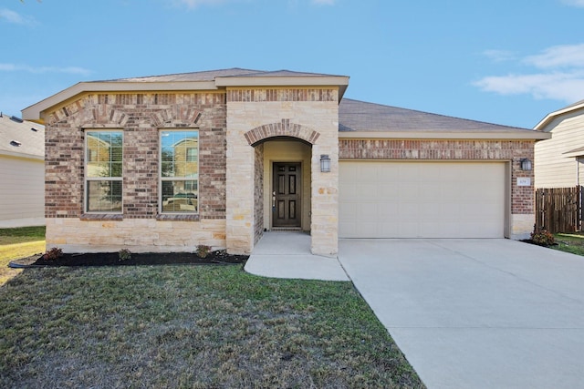 view of front of home with a front lawn and a garage