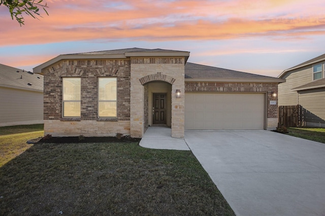 view of front facade with a lawn and a garage