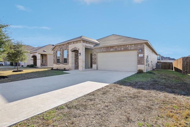 view of front facade with a garage, cooling unit, and a front lawn