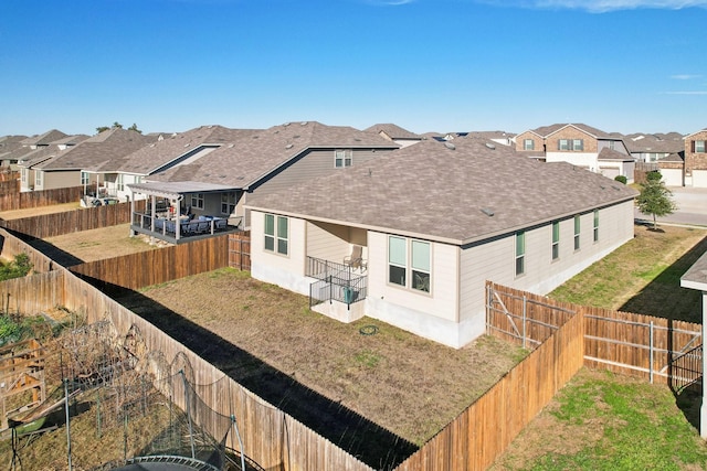 rear view of property featuring a yard