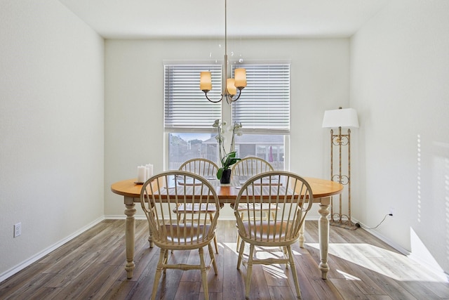 dining room with wood-type flooring and a notable chandelier