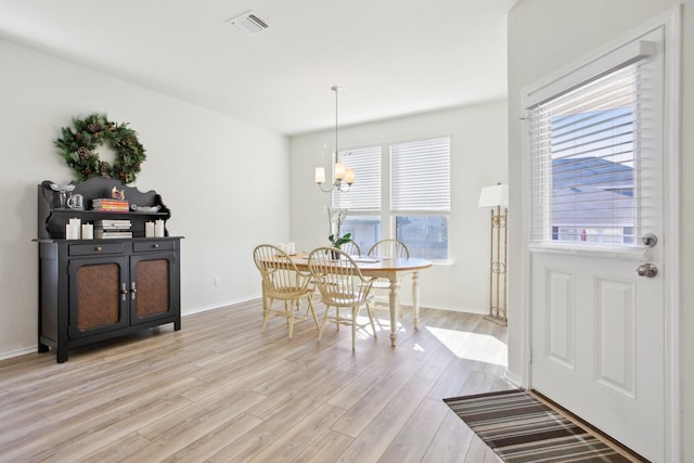 dining room featuring a chandelier and light wood-type flooring