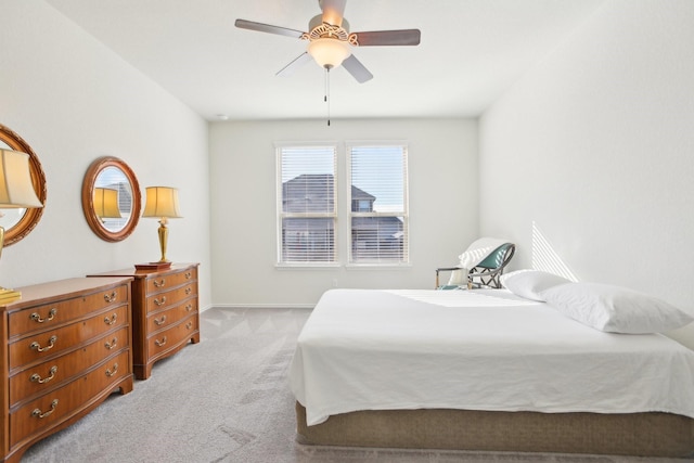 bedroom with ceiling fan and light carpet