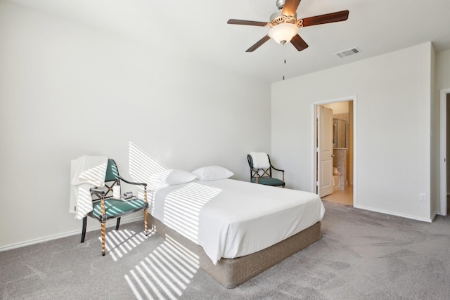 bedroom with ceiling fan, connected bathroom, and carpet flooring