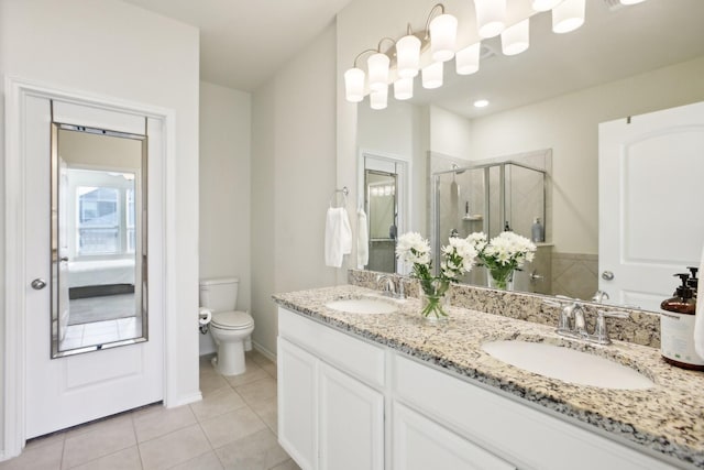 bathroom with toilet, tile patterned floors, a shower with shower door, and vanity