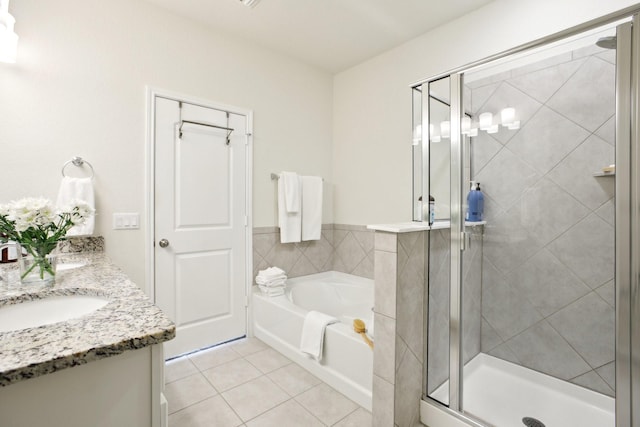 bathroom featuring independent shower and bath, tile patterned floors, and vanity