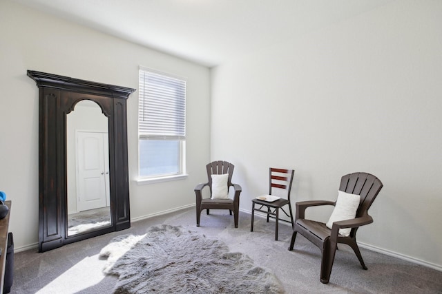 sitting room featuring dark colored carpet