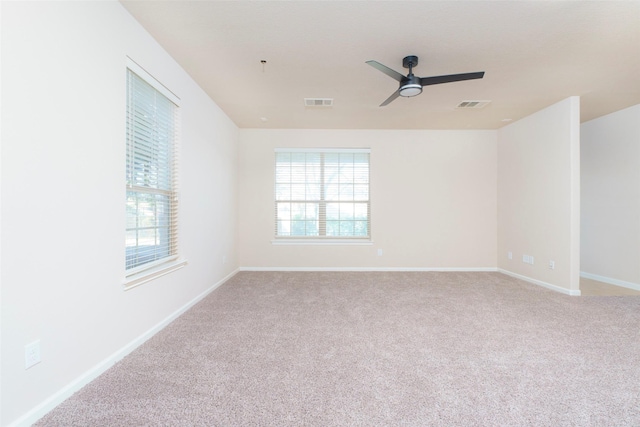 carpeted spare room with ceiling fan