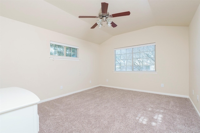 spare room featuring ceiling fan, lofted ceiling, and light colored carpet