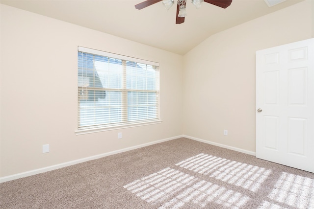 empty room with ceiling fan, lofted ceiling, and light colored carpet