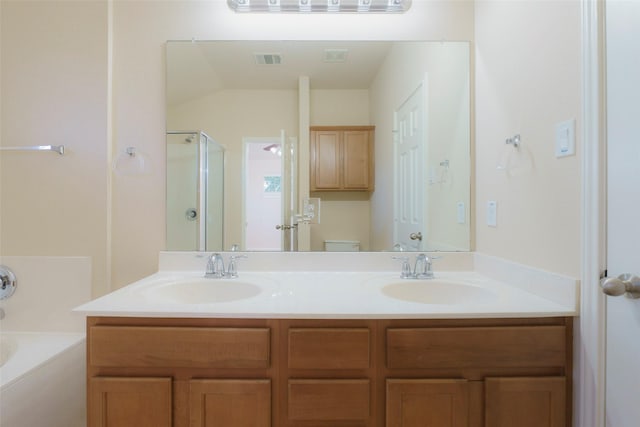 full bathroom with toilet, vanity, and separate shower and tub