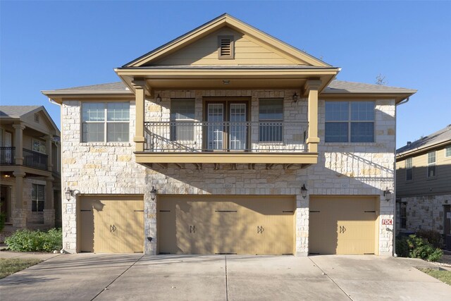 view of front of home with a garage and a balcony