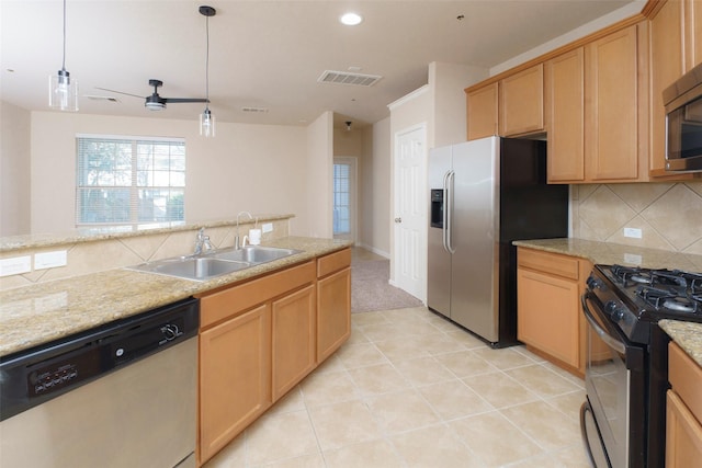 kitchen featuring appliances with stainless steel finishes, decorative light fixtures, sink, backsplash, and ceiling fan