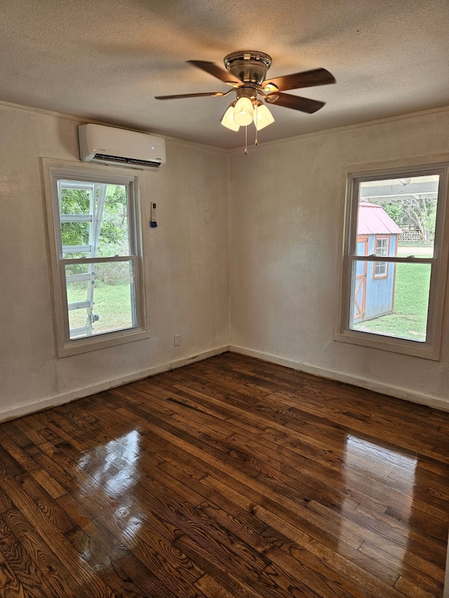 empty room with an AC wall unit, a textured ceiling, dark hardwood / wood-style flooring, and ceiling fan