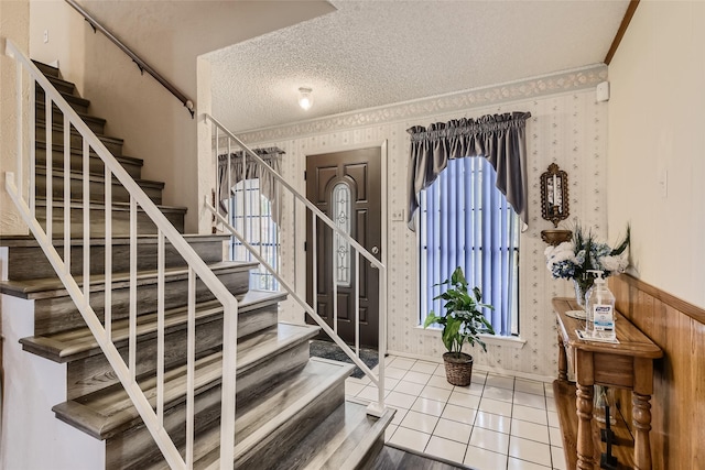 tiled foyer entrance featuring a textured ceiling