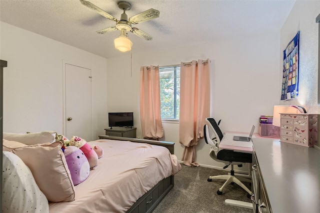 carpeted bedroom featuring ceiling fan and a textured ceiling