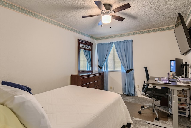 carpeted bedroom with ceiling fan and a textured ceiling