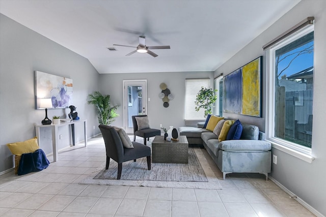 tiled living room featuring ceiling fan, a healthy amount of sunlight, and vaulted ceiling