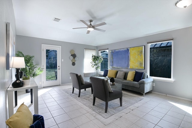 living room with ceiling fan and light tile patterned flooring