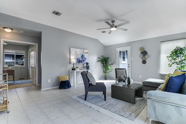 living room featuring ceiling fan, vaulted ceiling, and light tile patterned flooring