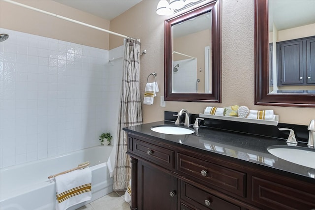 bathroom with tile patterned flooring, shower / bath combo, and vanity